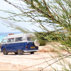 Camper van parked by a beach